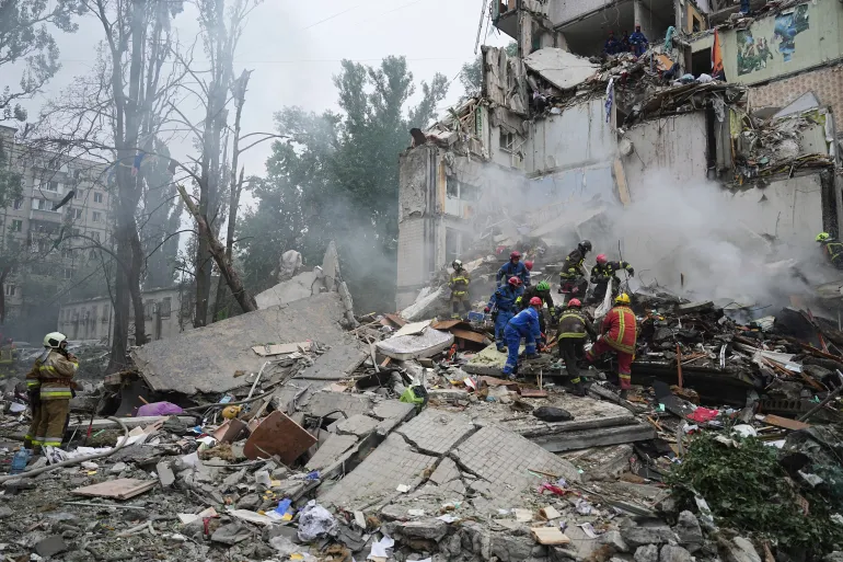 Rescuers work in a destroyed apartment building after a Russian missile attack in Kyiv, Ukraine, on July 31, 2025.